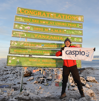 Caspio CEO Frank Zamani atop the Uhuru Peak on Mt. Kilimanjaro.